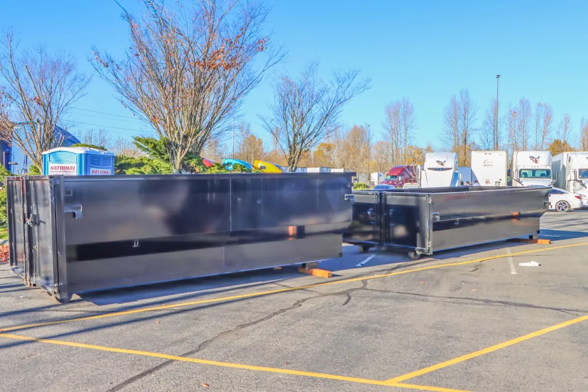 Professional dumpster rental service with roll-off container on residential driveway in Dakota Ridge